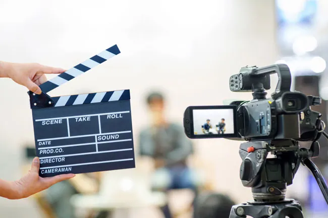 Image showing the clapboard and camera shooting of Brand video