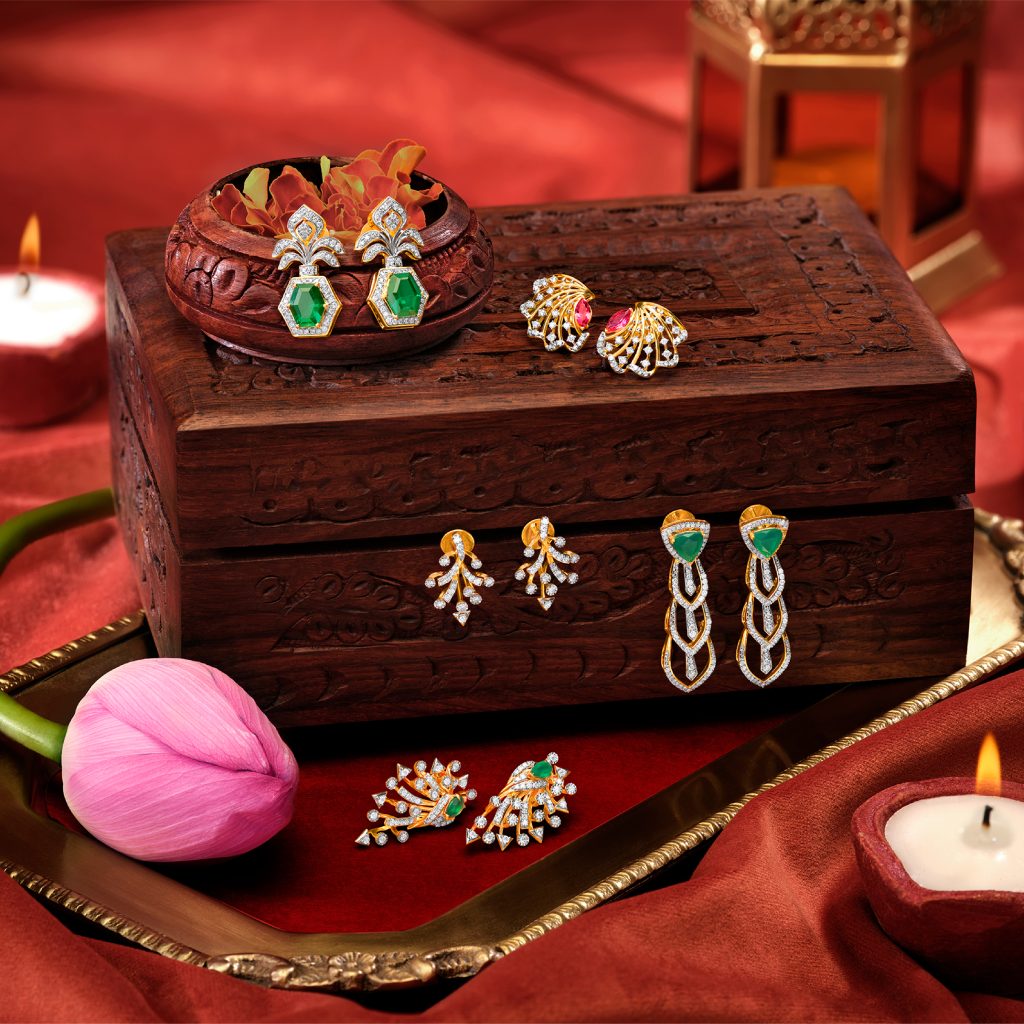 Diamond and gold earing jewellery product shoot on wooden box and red background